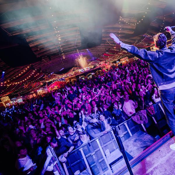 Singer in front of a cheering crowd